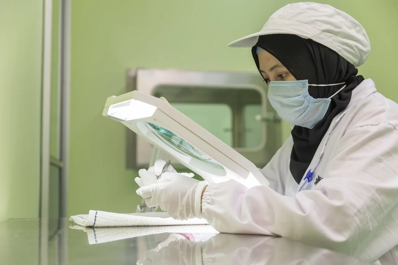 A team member inspecting bird’s nest under a magnifying lamp